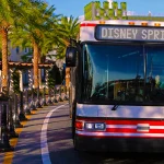 Disney Springs exigirá reservas para ônibus dos hotéis Disney volta a exigir reservas para embarque nos ônibus de Disney Springs para hotéis. Veja quem poderá utilizar o transporte. Ônibus da Disney em Disney Springs realizando transporte para hotéis Disney